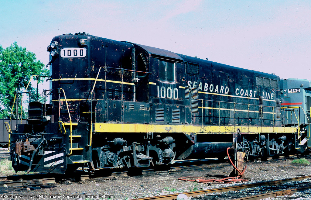 Seaboard Coast Line GP7 #1000 and B23-7 #5150 are serving as power for SCL train #588, the Wadley Turn.  On the shop track 